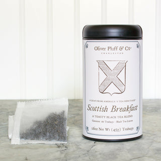 black tea tin stack of white mesh tea bags sitting on kitchen counter