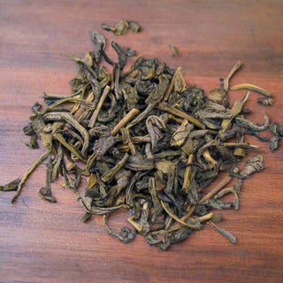 zoomed in view of loose leaf tea on wooden table