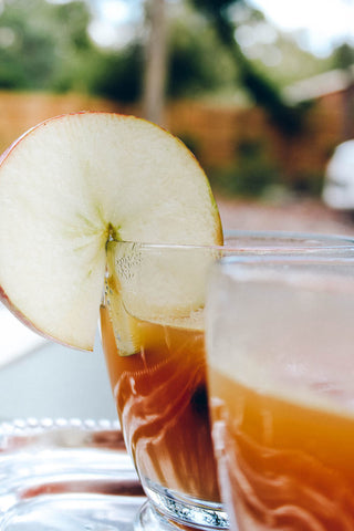 photo of fresh apple slice on cold glass of tea